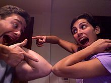 An elbow bump “Hello”