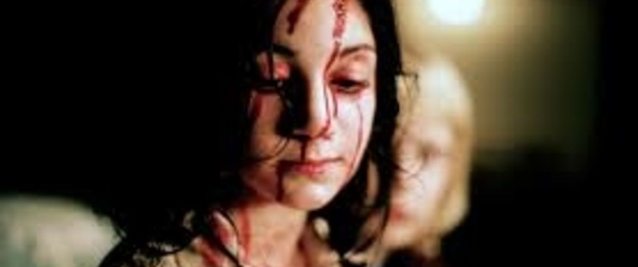 Wiping away the blood from her face. Wiping away the blood from her face.